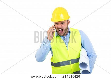 Angry upset young construction engineer yeling at the phone.