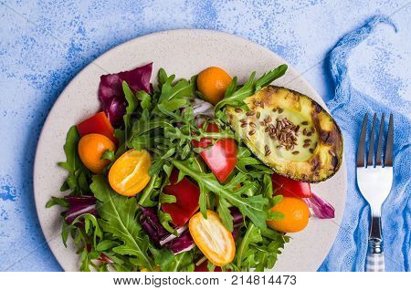 Raw arugula with vegetables and citrus. Selective focus.