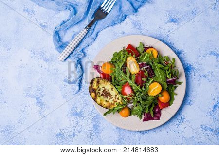 Raw arugula with vegetables and citrus. Selective focus.