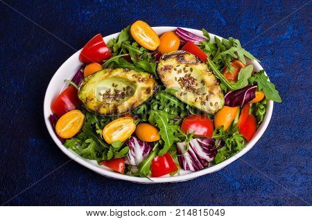 Raw arugula with vegetables and citrus. Selective focus.