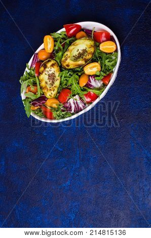 Raw arugula with vegetables and citrus. Selective focus.