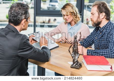 Couple Discussing Contract With Lawyer