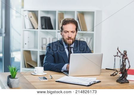 Lawyer Working On Laptop In Office