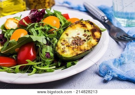 Raw arugula with vegetables and citrus. Selective focus.