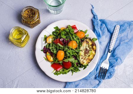 Raw arugula with vegetables and citrus. Selective focus.