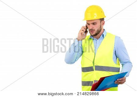 Angry upset young construction engineer yeling at the phone.