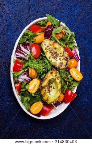 Raw arugula with vegetables and citrus. Selective focus.