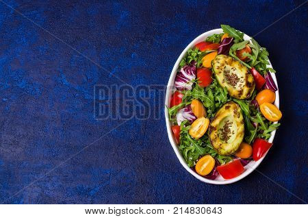Raw arugula with vegetables and citrus. Selective focus.