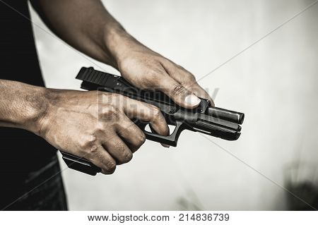 A man holding a gun in hand the ship ready to shoot the man pointed a gun at us. A man holding a gun was robbed.