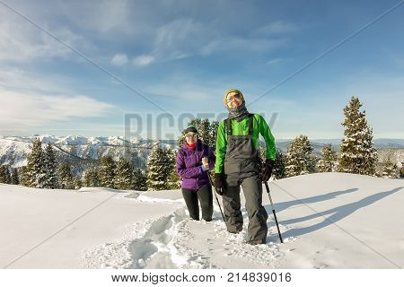 Two Happy Women Traveler With Backpacks Walking In Winter Mountains Forest