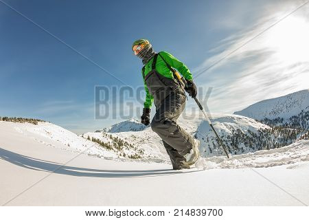 Happy Tourist Girl With A Backpack Walks In A Winter Mauntains Trees