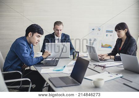 Young Business People Working Together With Serious Emotion. Business People Takling In Modern Offic