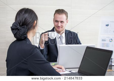 Man Discussing With Woman For Project With Attractive Smiling  At Office. Businessman With Happy Emo