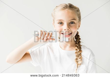 Child Holding Toothbrush