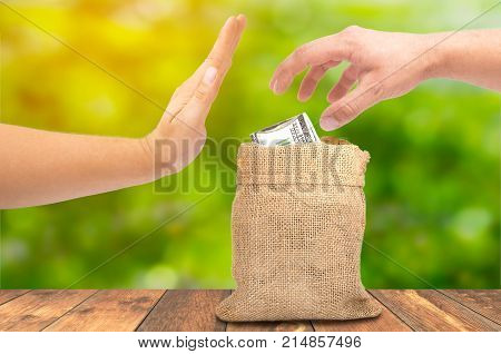 A theft money concept, A hand theft money from sack bag with dollar sign, corruption concept