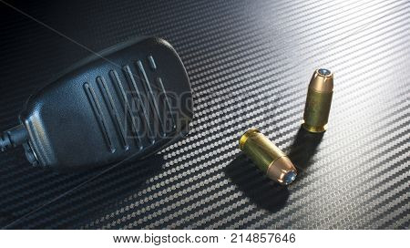 Self defense ammo for a handgun and a police microphone