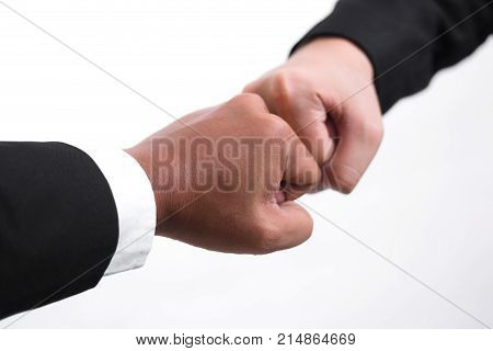 Close Up Of Young Asian Businessman Making A Fist Bump On White Background. Business People Wear Sui