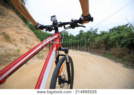 cyclist hands cycling mountain bike on trail