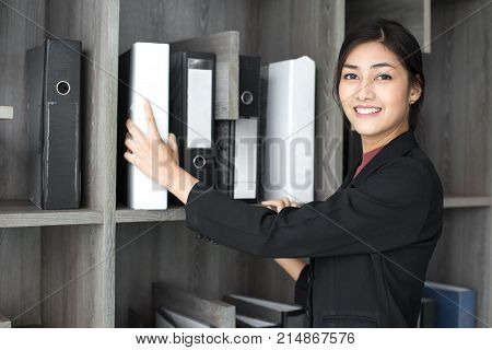 Asian Woman Holding Document At Working Place, Woman Working Concept.