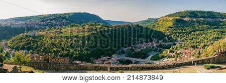 Panoramic view of Veliko Tarnovo from Tsarevets hill. Medieval ruins of Tsarevets fortress and typical terrace architecture in Veliko Tarnovo, Bulgaria