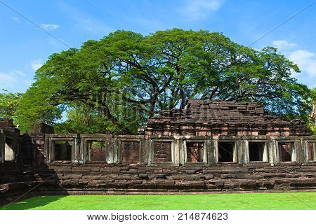 Phimai Historical And Ancient Stone Castle In Thailand And Big Tree