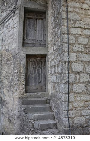 An old wooden door in a derelict building the historic hill village of Erto in Friuli Venezia Giulia north east Italy