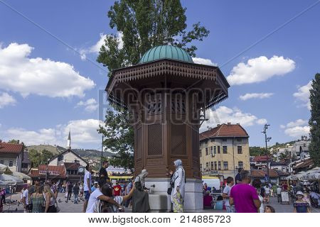 SARAJEVO, BOSNIA AND HERZEGOVINA - AUGUST 18 2017: Sarajevo city centre at day time in summer season with the sebilj fountain and people around