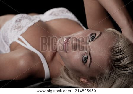 Beautiful Blond Woman On Bed With Black Saten Sheets