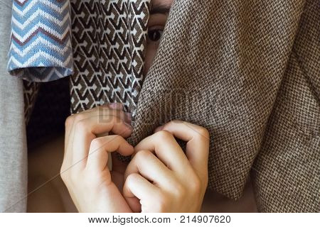 a young man hiding in the closet women's clothing