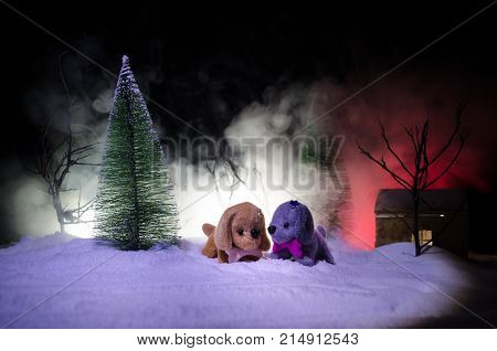 Toy Dog - A Symbol Of The New Year Under The Snow Against The Background Of Fir Branches. Toy's Dog 