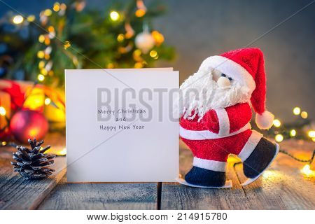 Decorative Santa Claus Carrying Greeting Card With Best Wishes On The Festive Dark Background With C