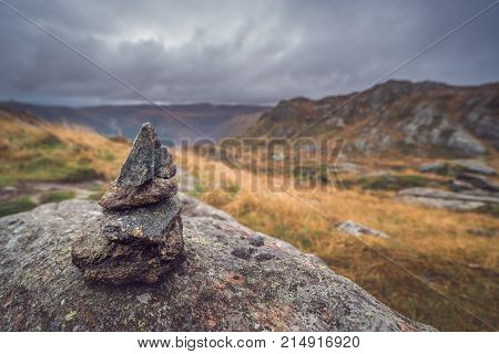 Zen balanced small pile of stacked stones on a walking path starting on top of Mount Ulriken in Bergen, Norway
