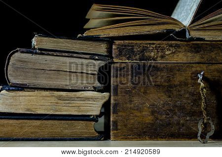 Old Rolls And Plans In Folded Paper Rolls. Old Book And Case. Documents On An Old Wooden Table.