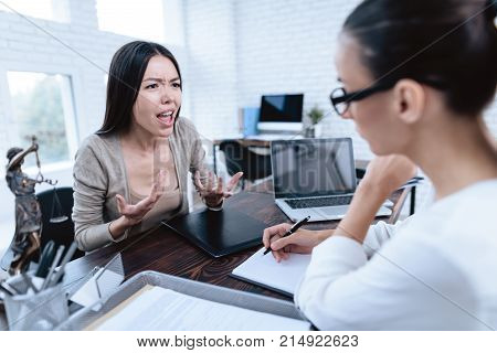 The couple went to a lawyer to conclude an agreement on the divorce. They quarrel and argue with each other. Lawyer prepares documents.