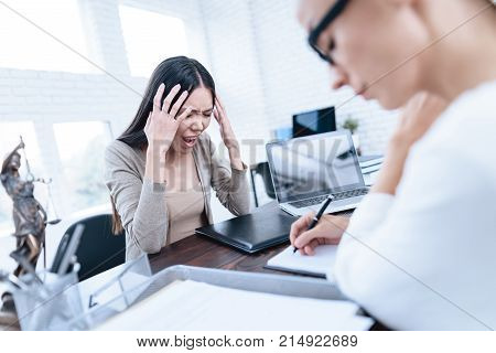 The couple went to a lawyer to conclude an agreement on the divorce. They quarrel and argue with each other. Lawyer prepares documents.