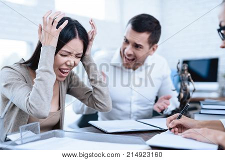 The couple went to a lawyer to conclude an agreement on the divorce. They quarrel and argue with each other. Lawyer prepares documents.