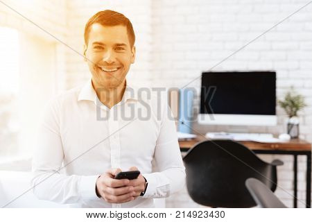 Young man smiles after the divorce. He is in the office of a lawyer. He is happy, he is in a good mood.