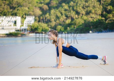 woman runner warm up before taking a jogging on beach