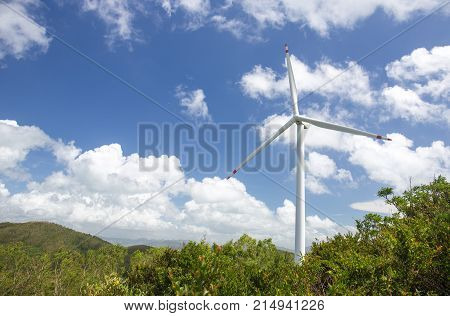 wind turbine system to produce green electricity for renewable energy at power station Lamma island Hong Kong with mountain and blue sky background and copy space