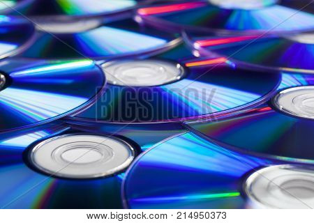 Pile of CD Compact Discs and DVDs with nice reflections