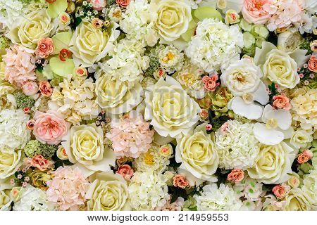 Beautiful artificial flowers background for wedding scene free space. Floral background copy space view from above. Holiday greeting card for Valentine's Day Woman's Day (March 8) Mother's Day