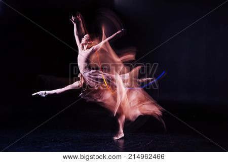 Hard work and persistence. Pleasant attractive skillful woman standing on stage and jumping while rehearsing a dance