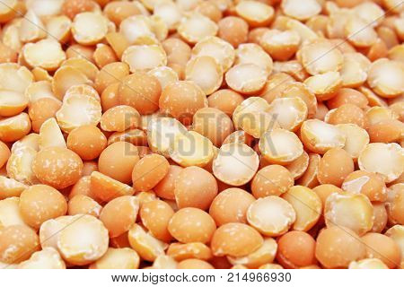 A background of split yellow peas. Yellow peas texture background pattern wallpaper. Healthy food. Studio photo texture photography. Texture background.