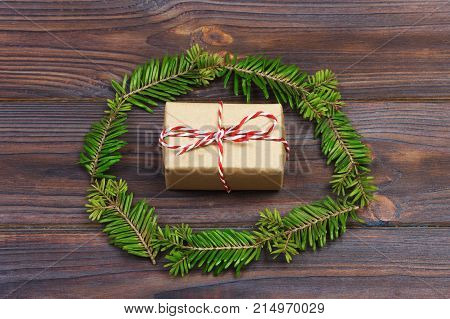Black wooden christmas background. twigs of thuja. Original fresh floral design for xmas card. empty space for holiday greetings.