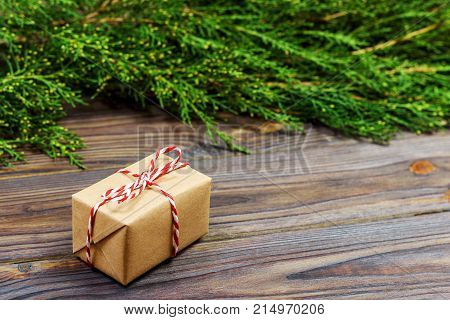 Black wooden christmas background. twigs of thuja. Original fresh floral design for xmas card. empty space for holiday greetings.