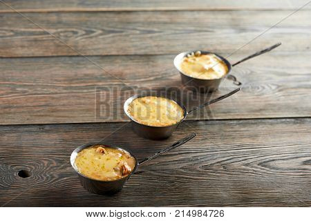 Hot appetizers julienne with mushrooms and cheese on wooden table copyspace serving appetite hunger eating restaurant menu food recipe tradition cooking cusine.