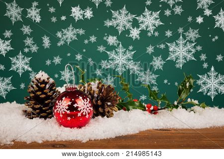 Christmas bauble still life with pine cones holly and snowflakes.