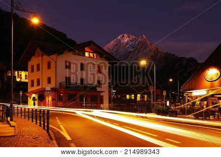 CANAZEI, ITALY - OCTOBER 27 - 2016 - Nightscape in Canazei Resort with Peak Vernel, the base station for many excursions and rock climbs to the Sella Marmolada and Sassolungo Group, Dolomites, Italy