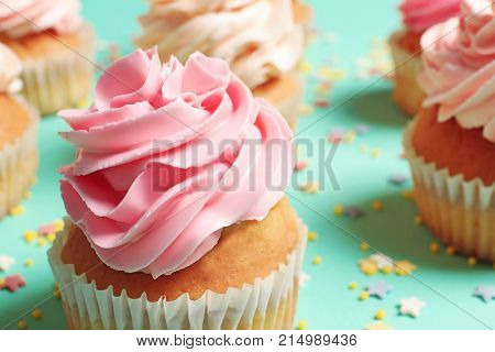 Yummy cupcakes on color background
