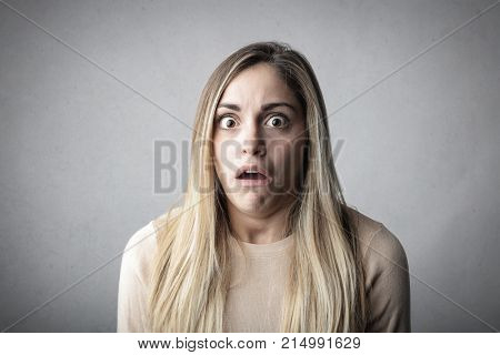 Schocked girl on neutral background
